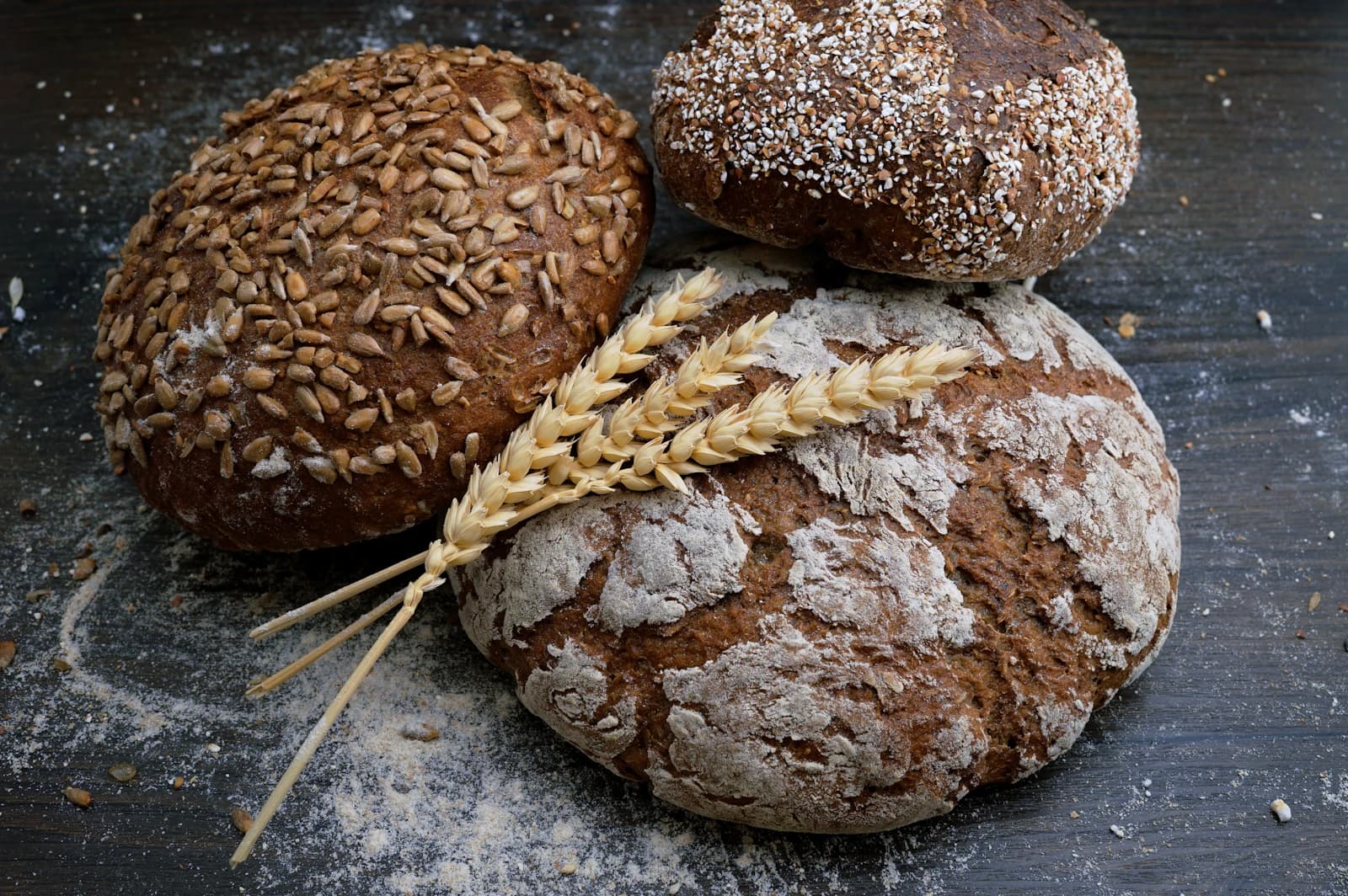 Freshly baked loaves of bread with ears of wheat
